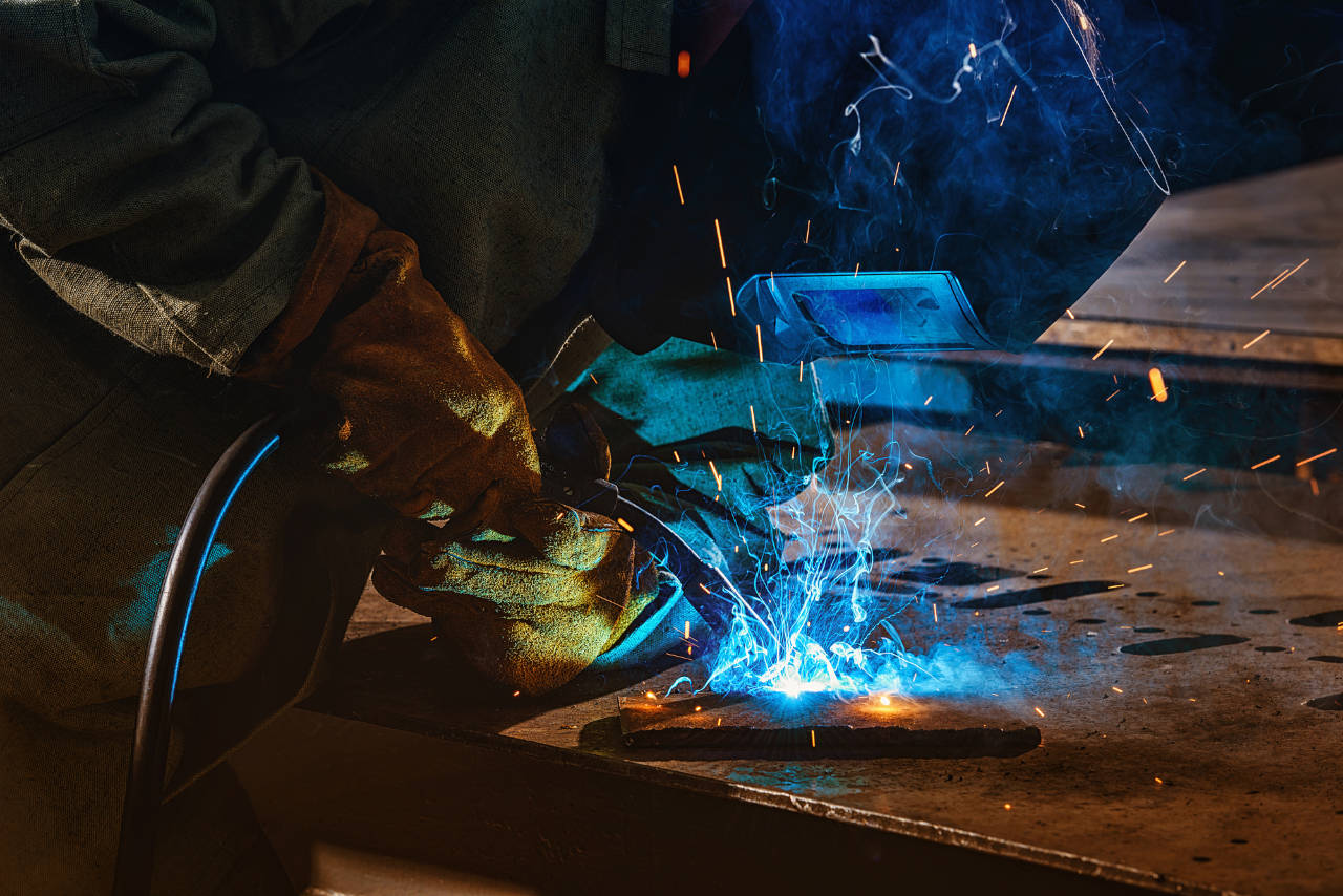 Welder using torch on steel