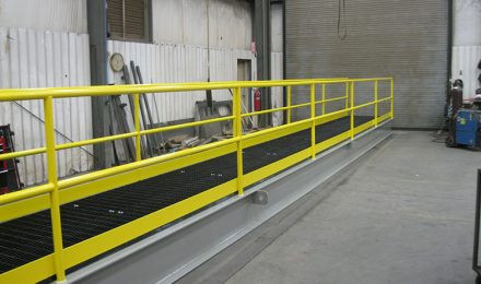 Yellow painted custom steel fabricated platform bridge left angle view