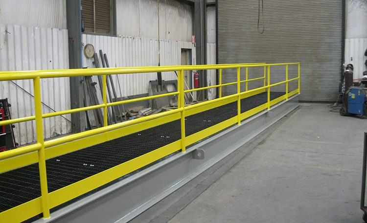 Yellow painted custom steel fabricated platform bridge left angle view