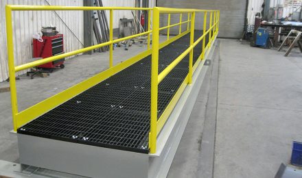 Yellow painted custom steel fabricated platform bridge side view