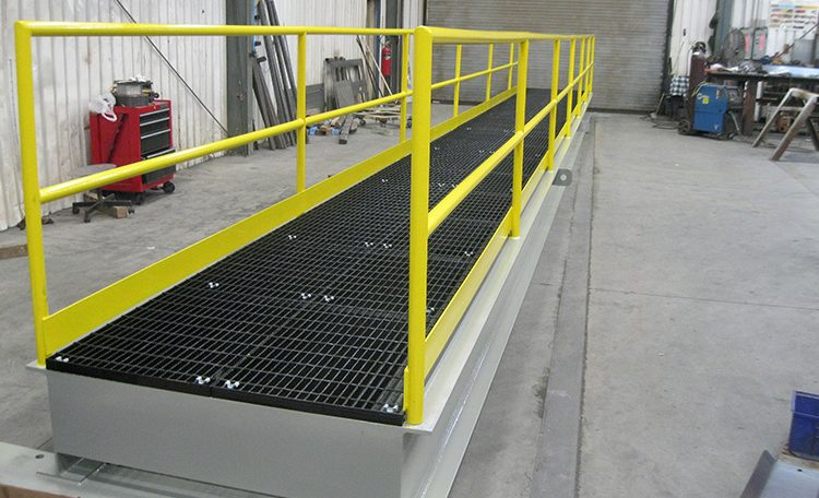 Yellow painted custom steel fabricated platform bridge side view