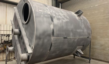 Unpainted rolled fabricated tank with outlets left angle view