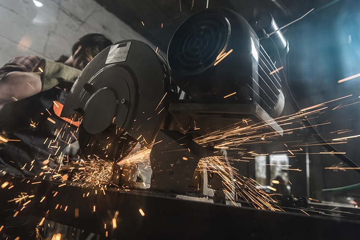 Welder using a welding torch and creating sparks